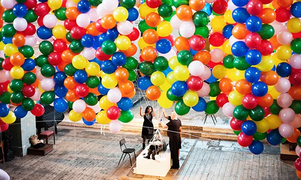 Up, up and away! Disabled artist lifted off the ground by 20,000 helium balloons