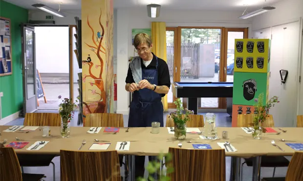 Silver service: Headway East London member Daniel hard at work setting up for one of their popular supper clubs. Photograph: