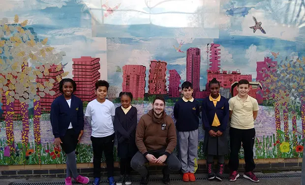 Pupils with London Wildlife Trust learning officer Aleksander Makucewicz in front of the spectacular mural they created