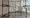 Art installation that is a series of metal poles forming a structure with shelves. On the shelves are cassettes and other ite