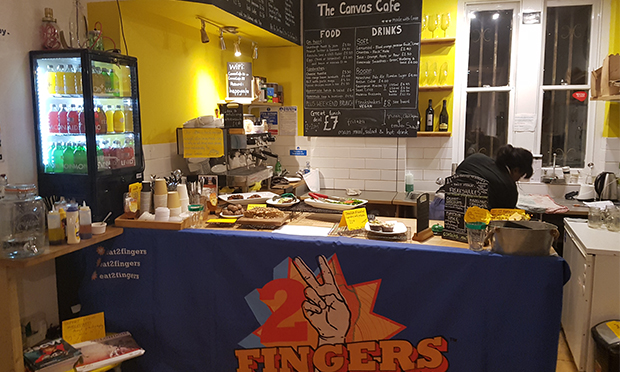 The Canvas Cafe counter, resplendent with 2 Fingers banner.