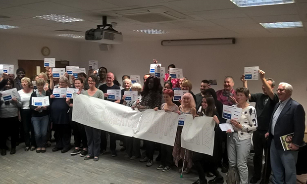 Attendees at the Healthwatch Hackney meeting hold a 'Save Homerton Path Lab' banner. Photograph: Healthwatch Hackney 