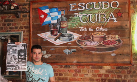 Owner Roberto Hernandez with his 'Latin Night' poster