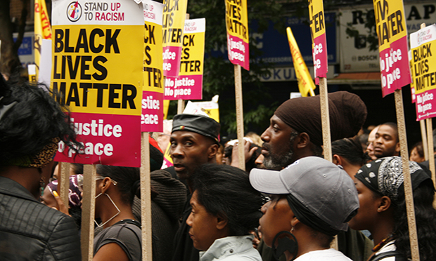 Demonstrators carrying Black Lives Matter placards