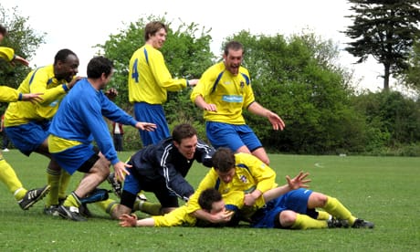 The goalscorer is mobbed by his team mates Photo: © Mel Roberts  