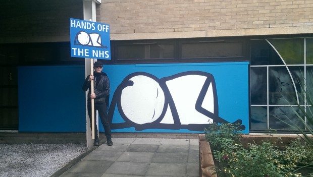Stik stands next to his 'Sleeping Baby' mural in Homerton Hospital courtyard. Photograph: Hackney Citizen