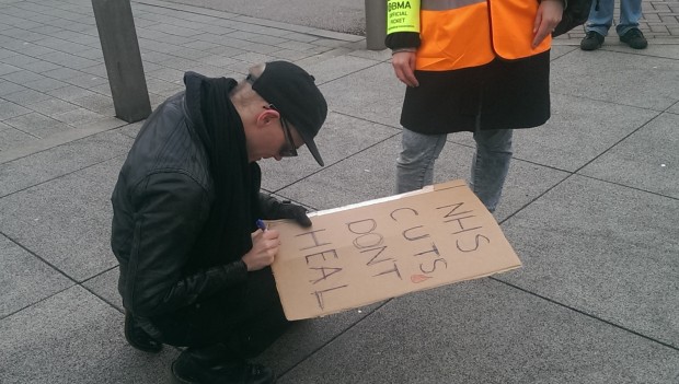 Stik signs a fan's placard. Photograph: Hackney Citizen