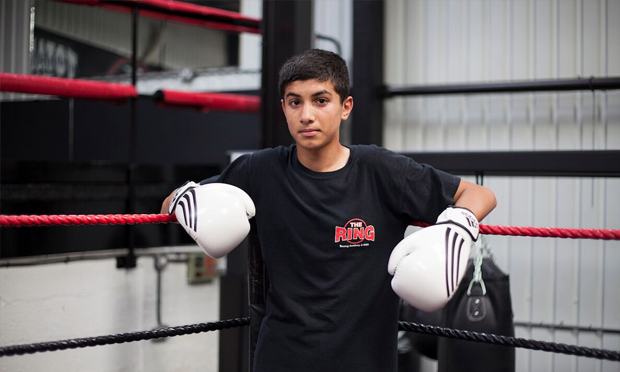 Young boy, white boxing gloves from You Get Me? by Mahtab Hussain © the artist