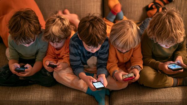 an image showing kids looking at social media screen