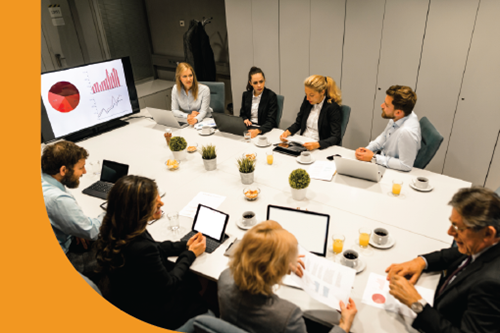 A group of professionals sitting at a boardroom table.
