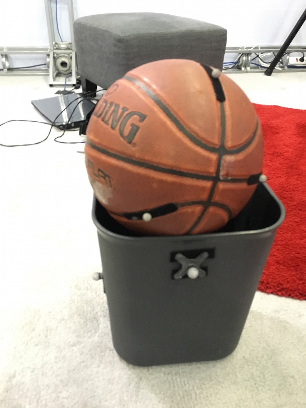 A basketball and trash can that are being brought into VR by Project Alice.