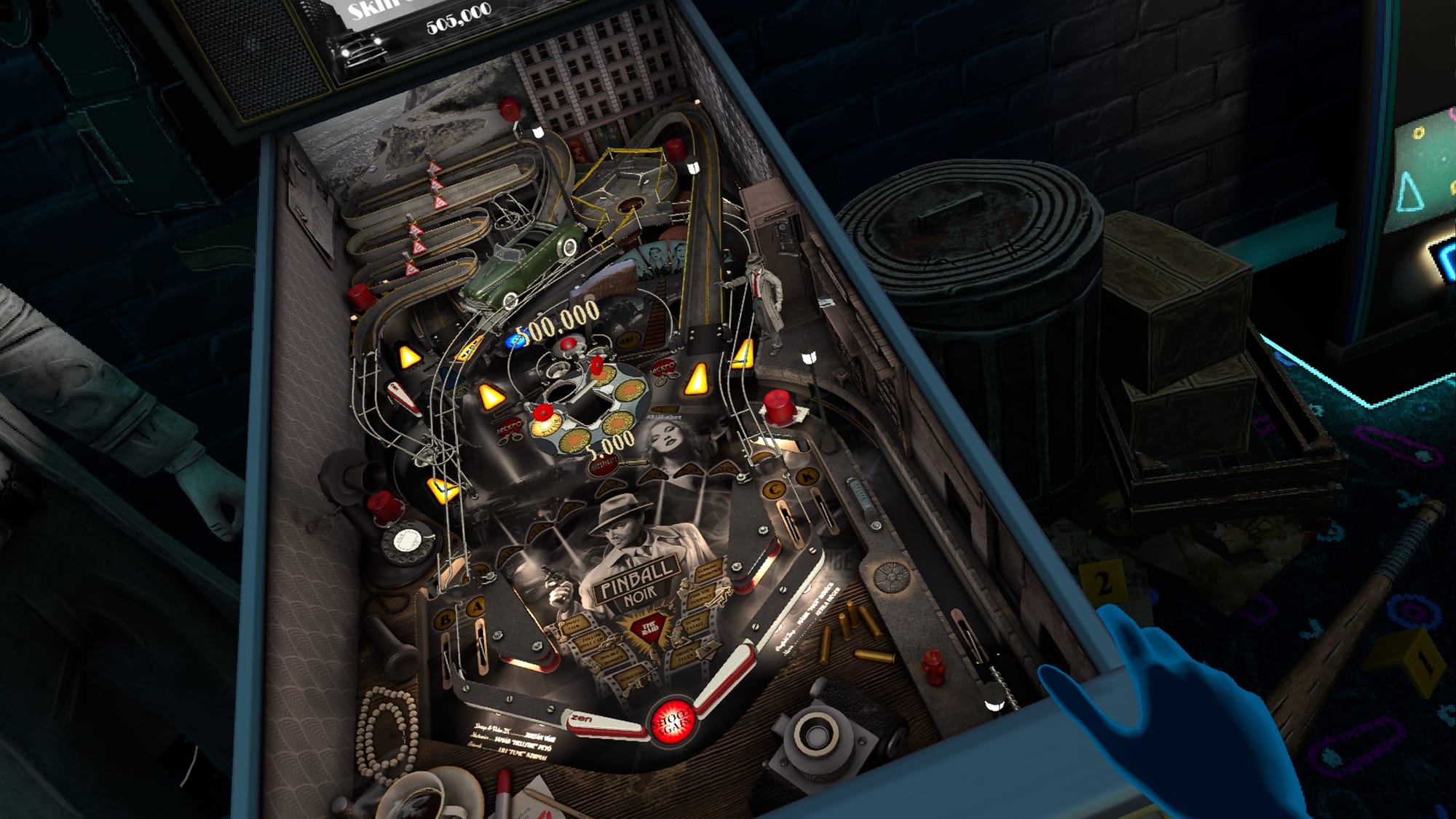 a hand is rested on the right side of the pinball noir table