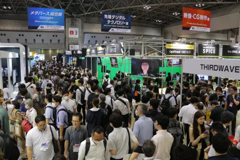 A large group of people walking across a convention centre