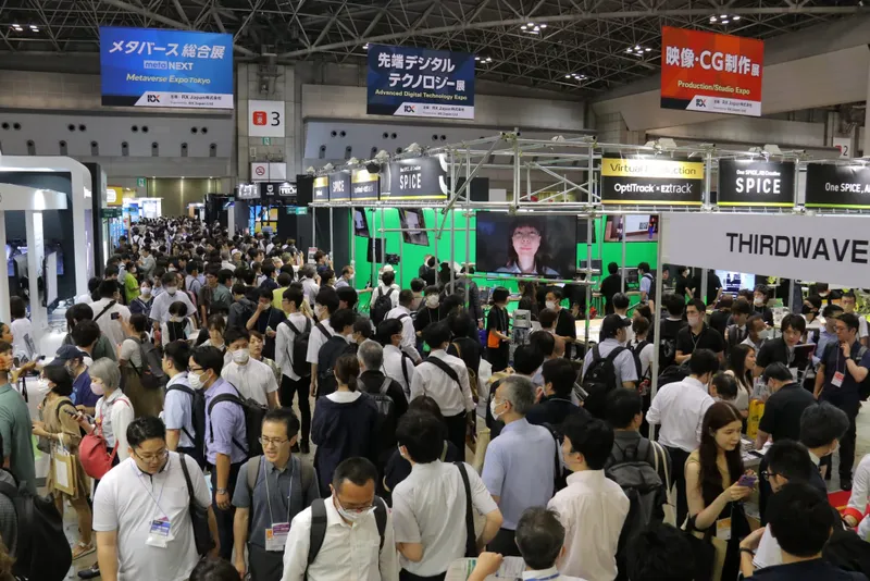 A large group of people walking across a convention centre