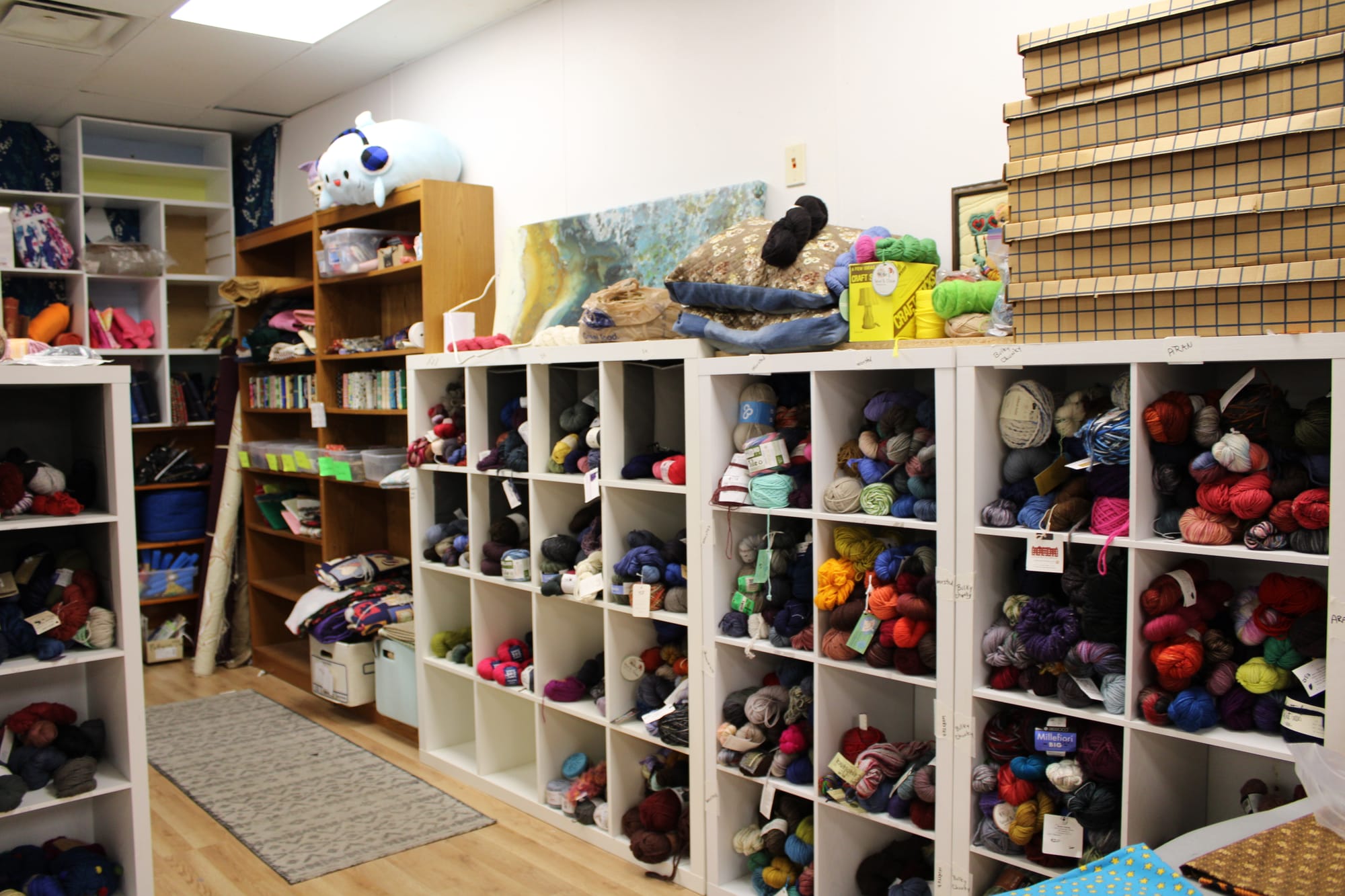Shelves filled with yarn and textile craft supplies