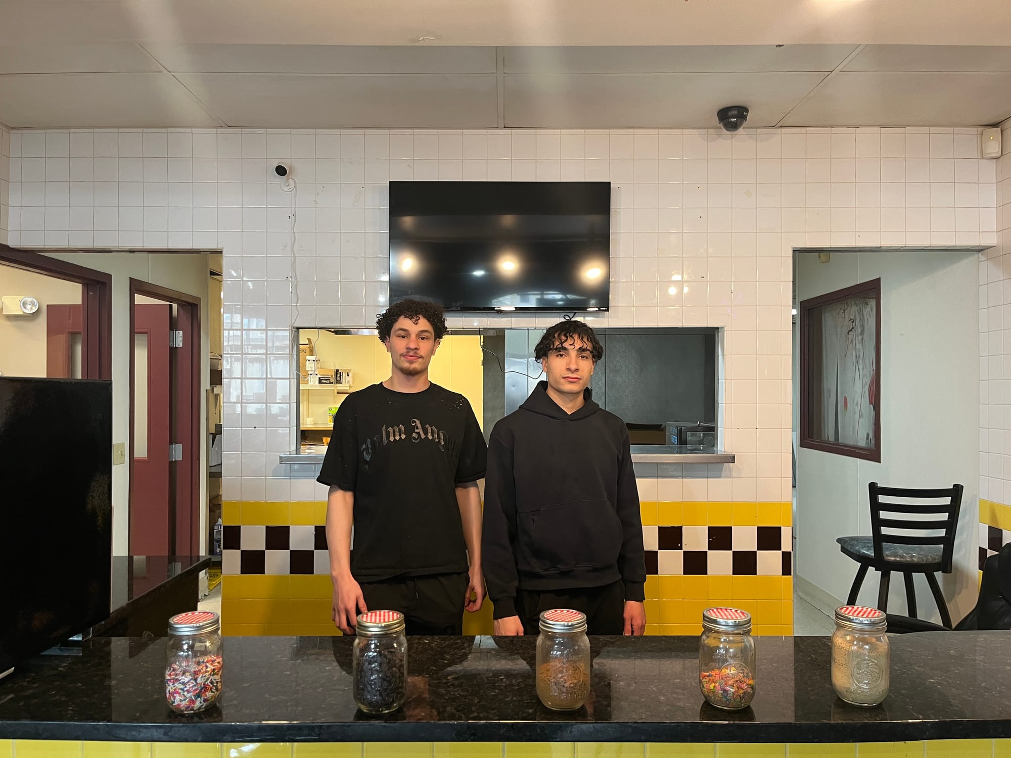 Samu Abu-Attiyeh and Yousef Zayed stand behind the counter in Chocolate Euphoria