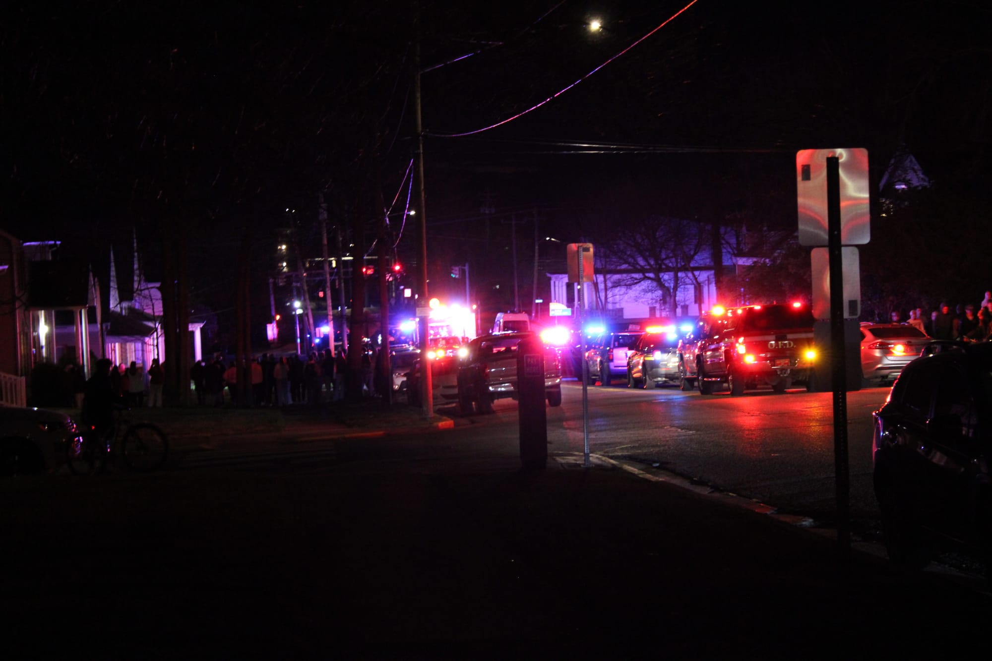 Red and blue first responder lights on a dark street