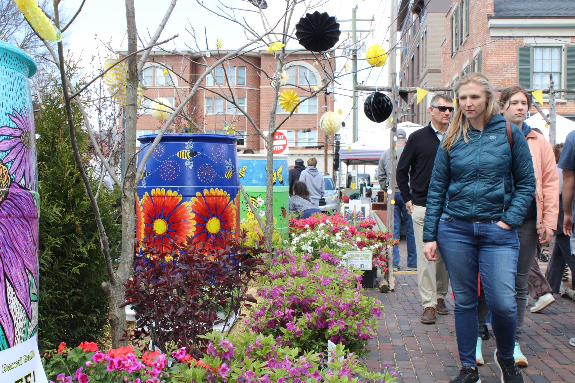Rain barrels and flowers lined a High Street walkway