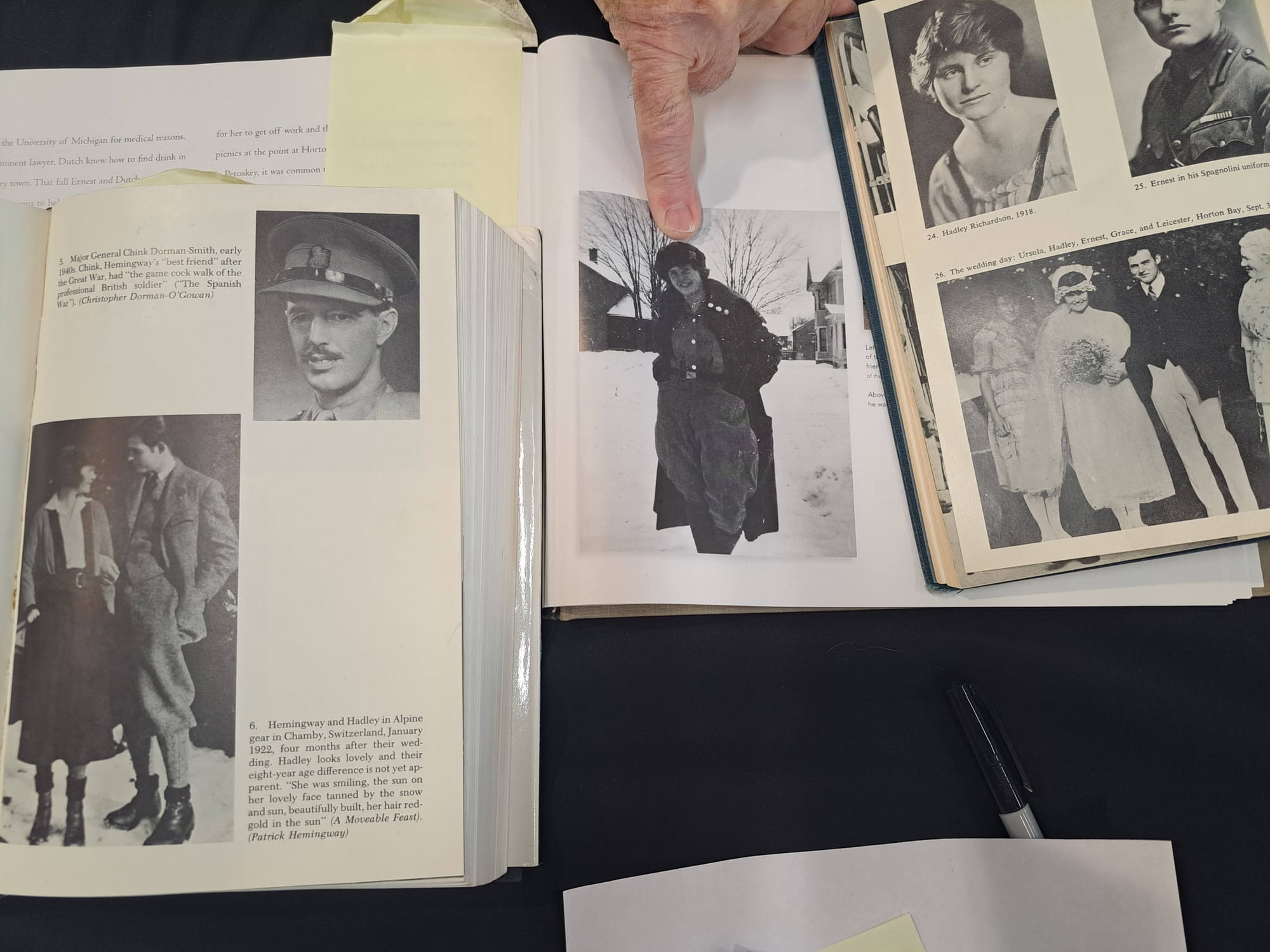 Multiple books open with black and white photos displayed