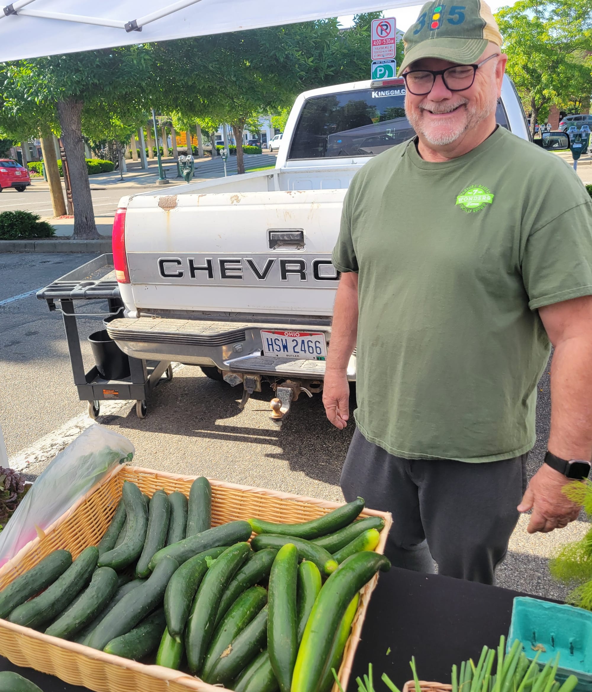 7 Wonders farm stand at the Oxford Farmers Market, which has a basket of cucumbers