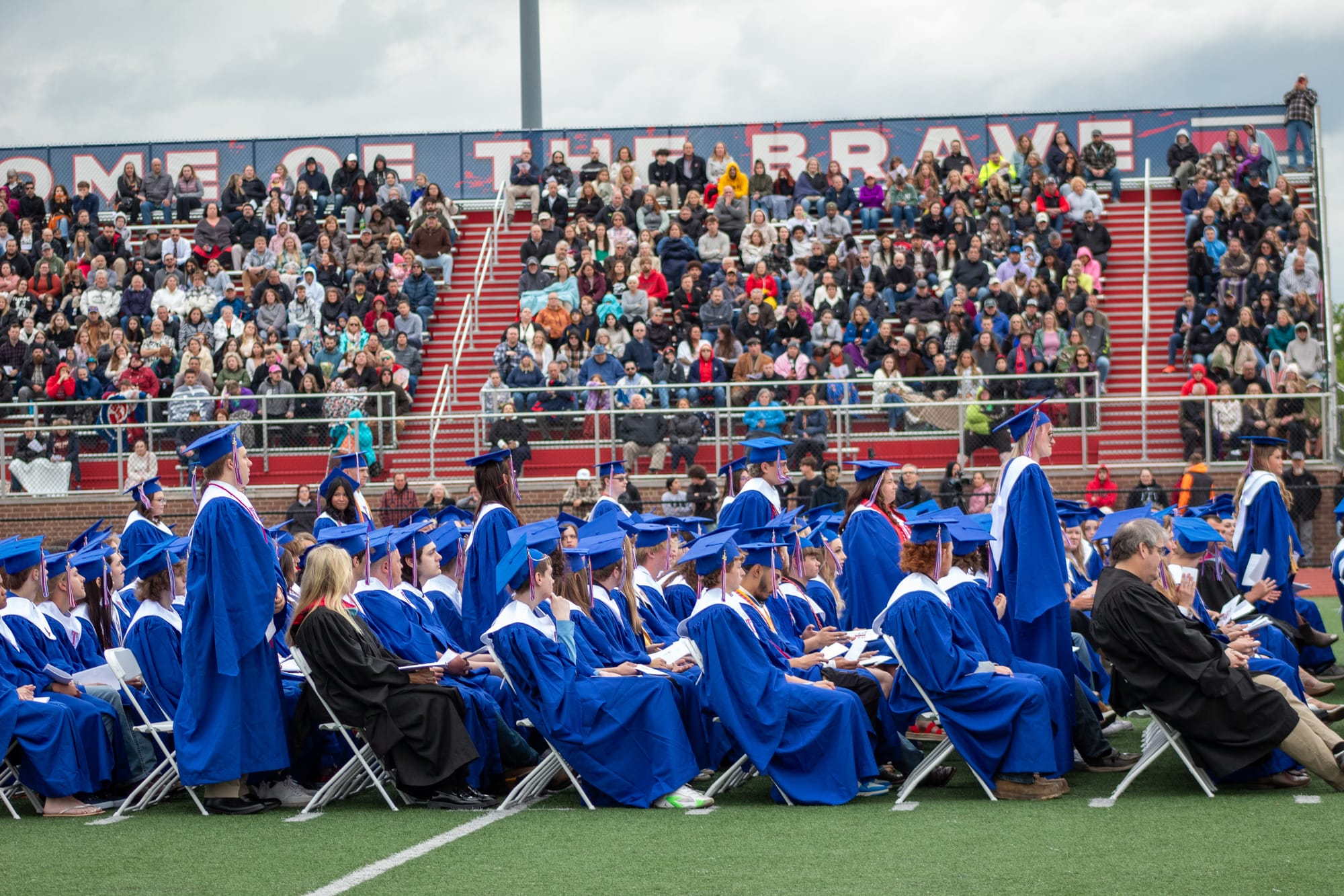 A few students stand as they are recognized for enlisting in the military or pursuing first responders or educators as a career