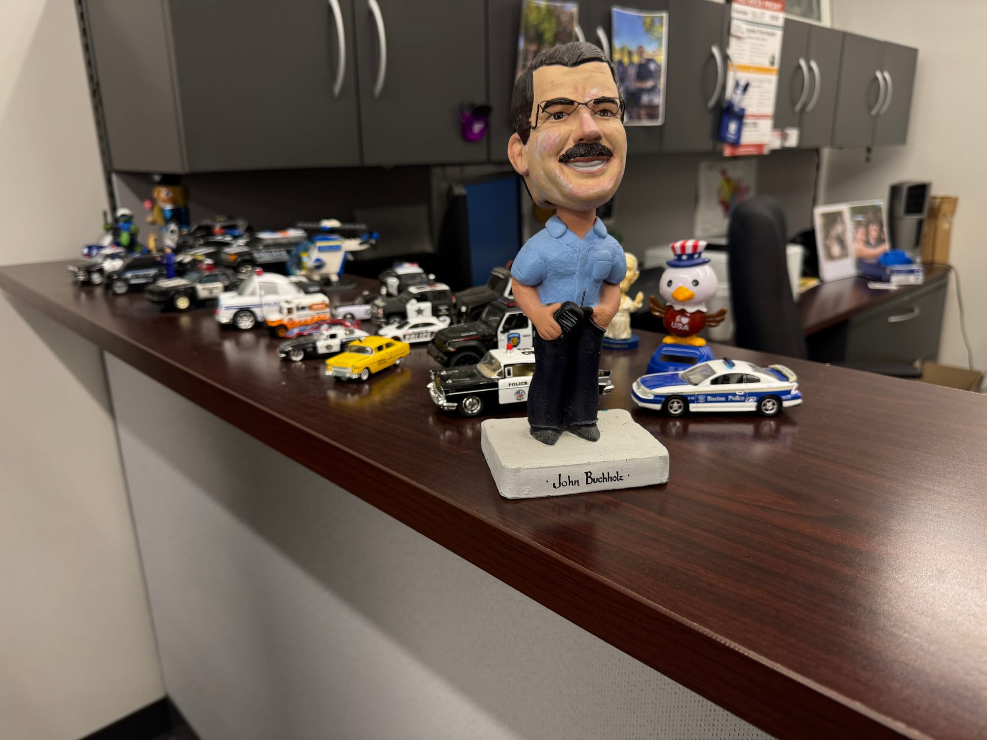 A bobblehead of John Buchholz that was gifted to him from his daughter sitting on his desk. 