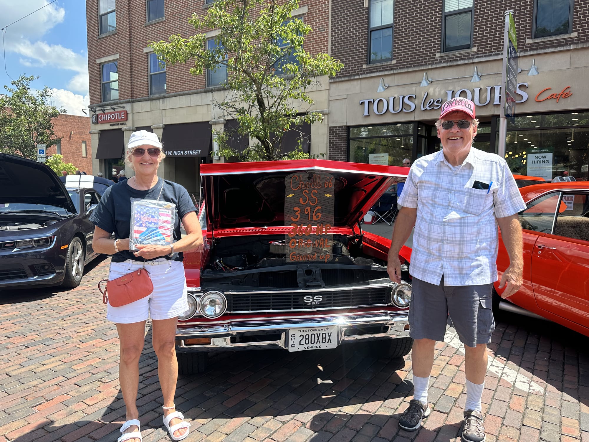 Kate and Steve Luken stand in front of a car they brought to the car show.