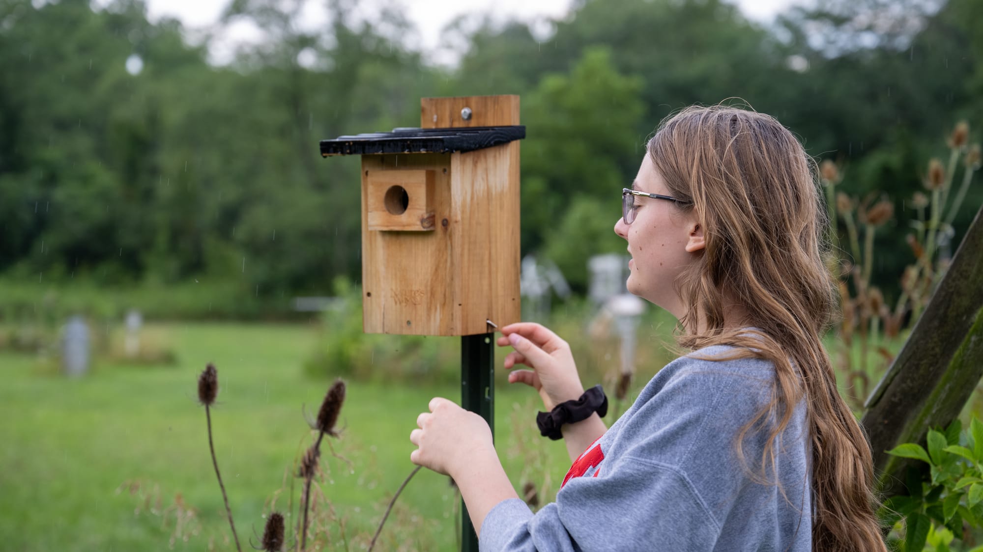Allison Helferich opens a bird box at the ERC.