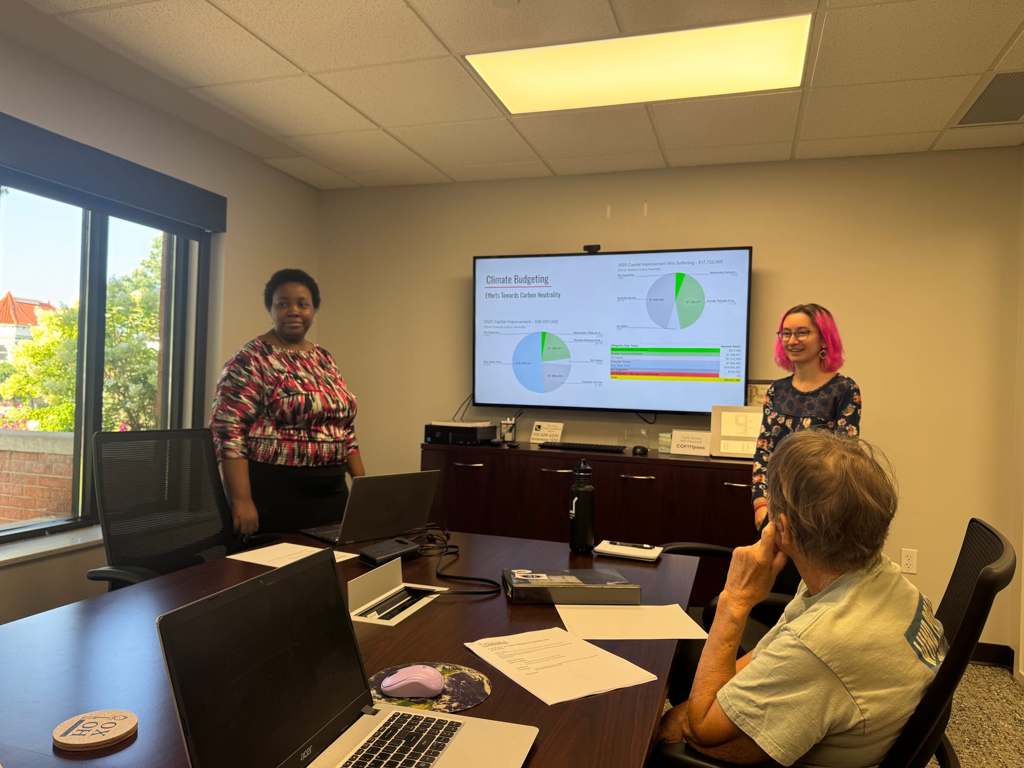 Kate Kozak and Oluwaseun Olubodun presenting their research from the summer to the Climate Action Steering Committee.