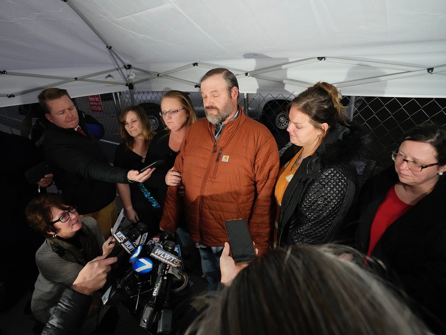 Patricia Gallagher Newberry (lower left) joins other reporters at a press conference