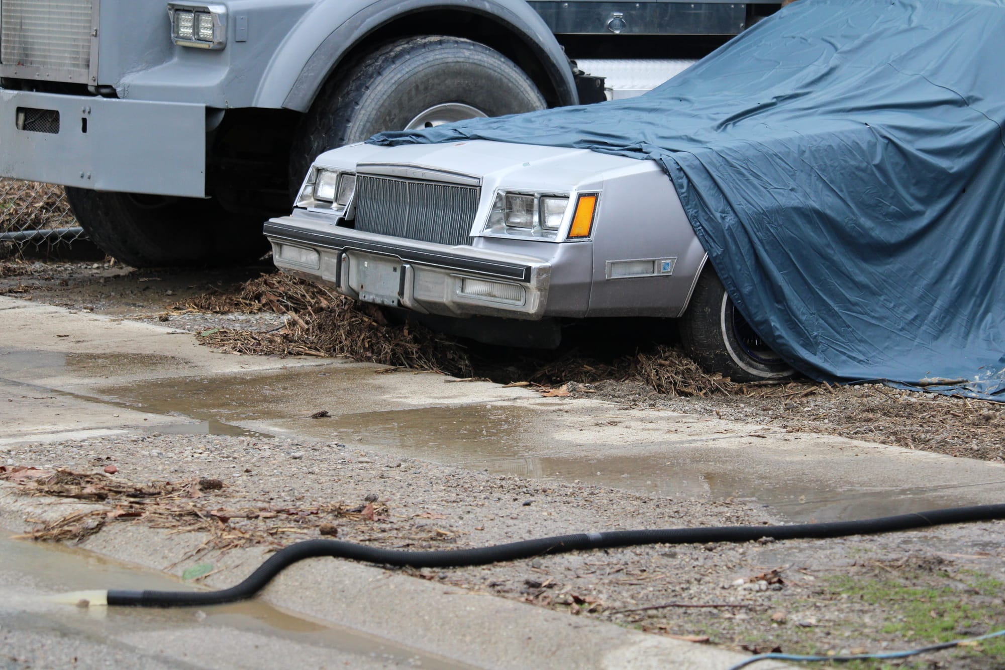 A car covered by a tarp