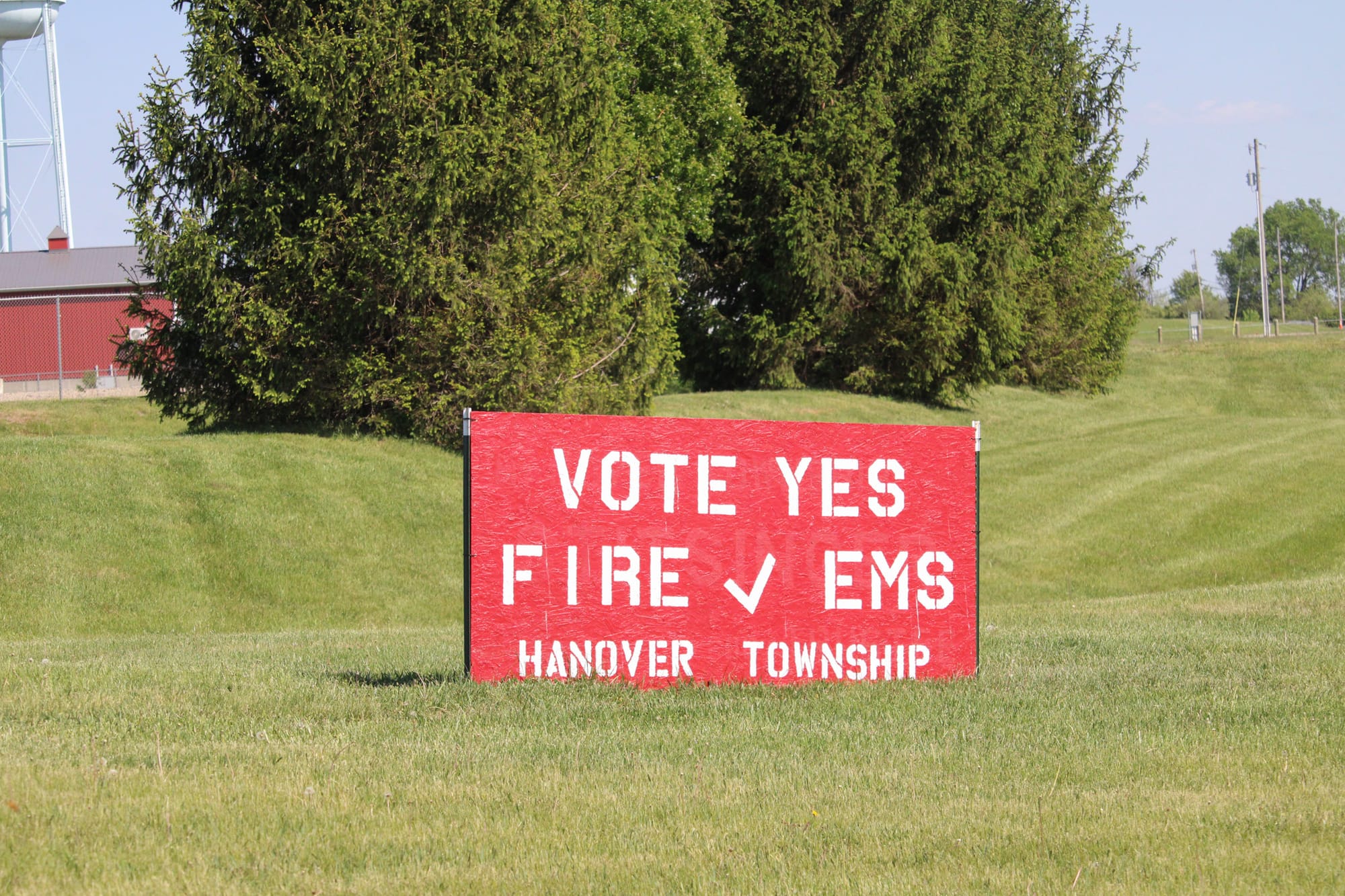 A red sign that reads "Vote yes," "Fire EMS," "Hanover Township."