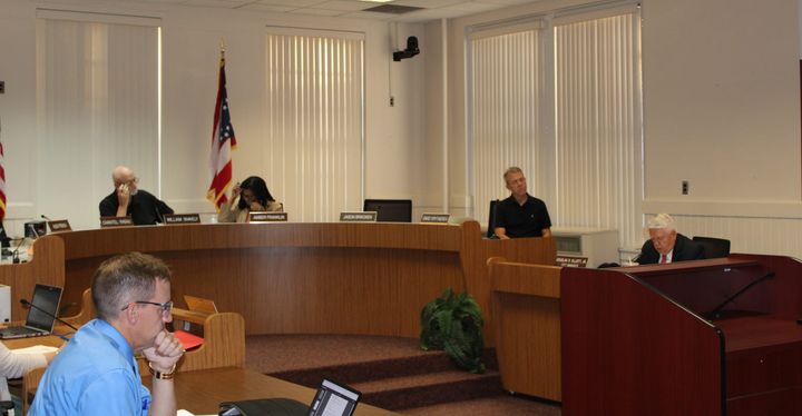 Oxford city council members and staff sit around a board table in the Oxford Courthouse