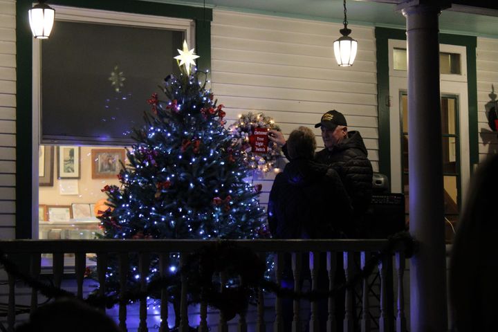 Donald Shupp and his wife Kathy stand next to a Christmas tree on a porch