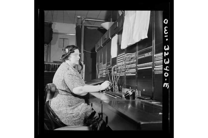 A black and white photograph of a telegraph operator