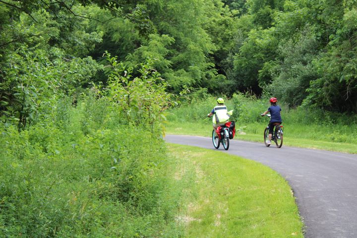Two bikers ride along the Oxford Area Trail