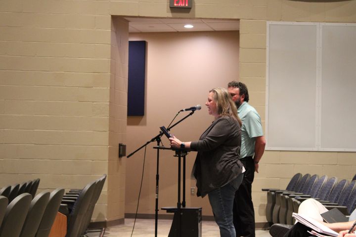 Molly Farler speaks at a microphone
