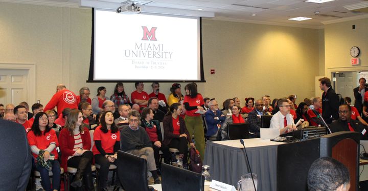 Faculty members pack into a Board of Trustees meeting