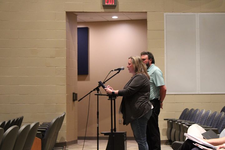 Molly Farler speaks at a microphone in the Talawanda auditorium