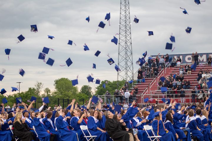 Talawanda's Class of 2025 throws their blue caps into the air after officially graduating