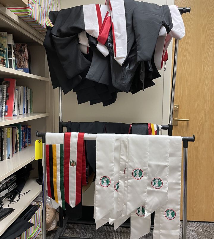 Graduation gowns and stoles are hung up, available for students to borrow