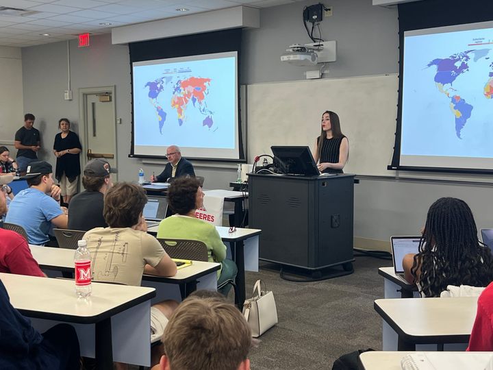Oleksandra Matviichuk stands in front of a room of students