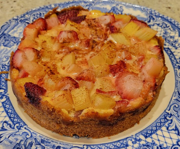A straberry and rhubarb tart on a China plate