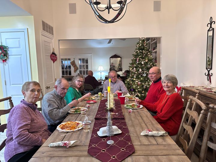Members of a Parkinson’s support group in Oxford sit around a table for a meal.
