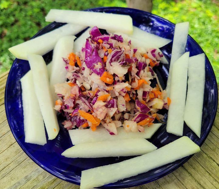 Raw kohlrabi cut into sticks in a bowl.
