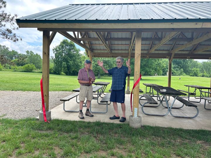 Ron Overly and Dave Eifert cut a red ribbon at the ceremony