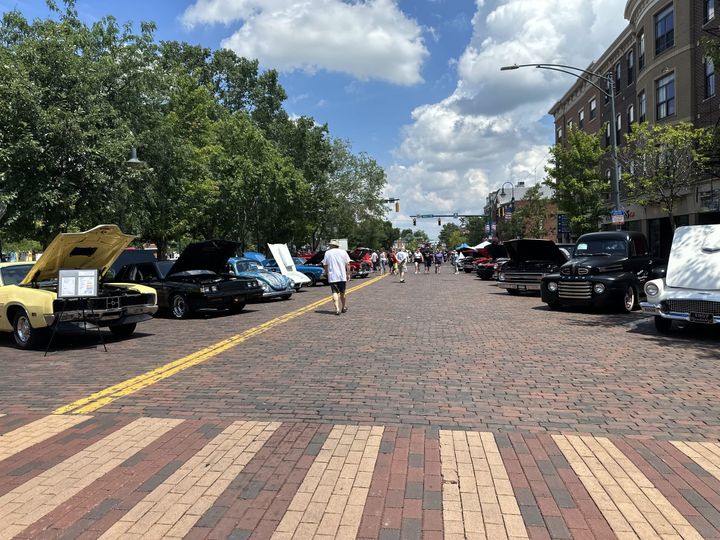Oxford residents walk on High Street looking at cars