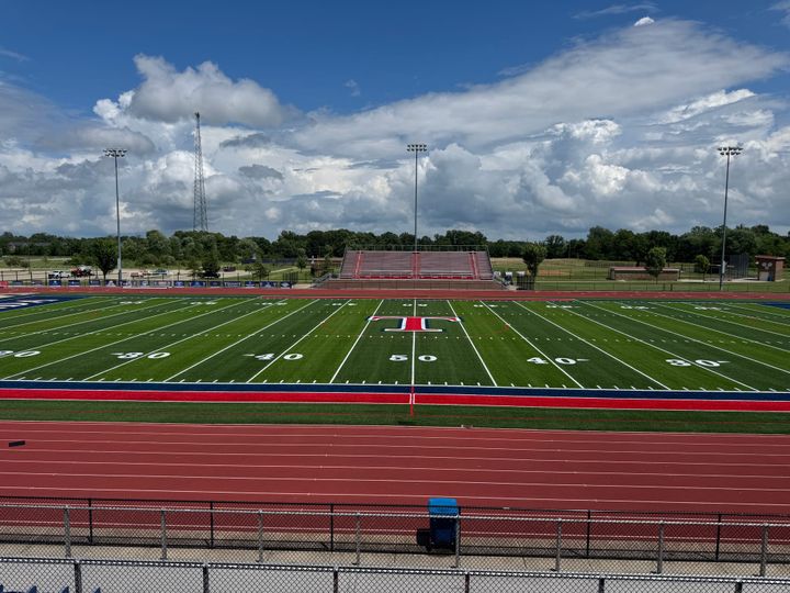 The Talawanda stadium has a green turf field with a red T in the middle