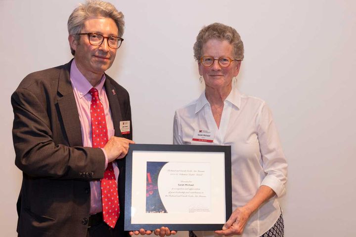 Sarah Michael (right) holds an award