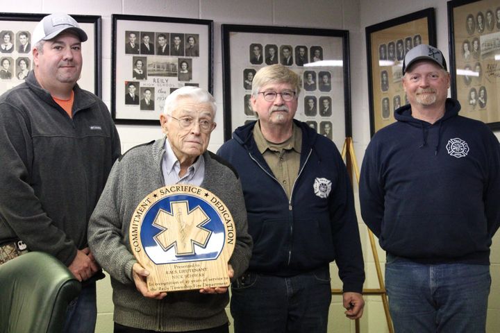 Nick Schwab, middle left, is honored during a Reily Township Board of Trustees meeting. Schwab is posed with Jeremy Sears, left, Randy Eaton and Clayton Lightfield.